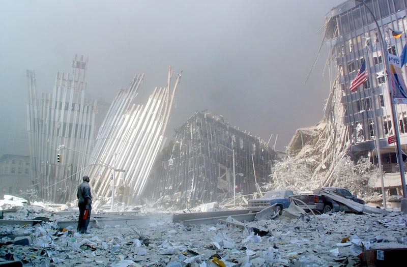A man stands in the rubble, and calls out asking if anyone needs help, after the collapse of the first World Trade Center Tower 11 September, 2001, in New York. Two hijacked planes crashed into the twin towers causing the collapse of both. AFP PHOTO Doug KANTER (Photo credit should read DOUG KANTER/AFP/Getty Images)