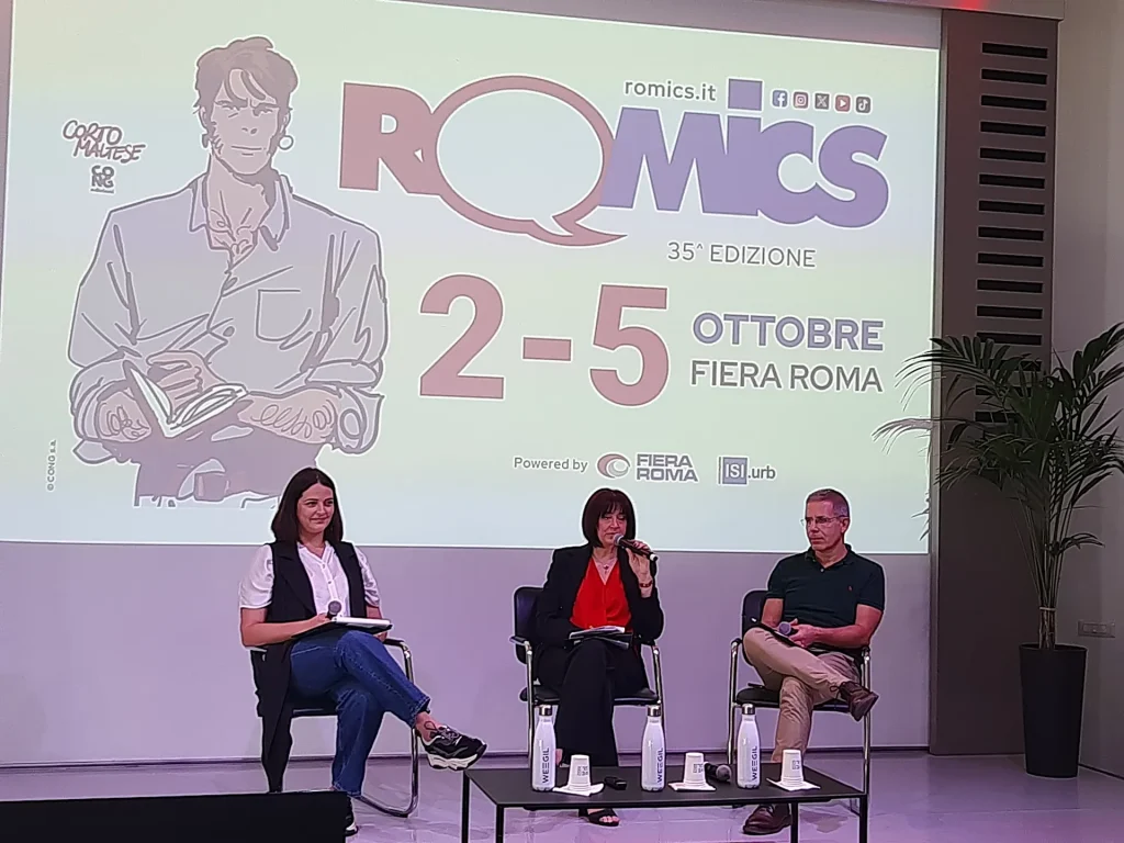 immagine per Conferenza stampa presentazione XXXV edizione Romics. Sullo sfondo il manifesto con Corto Maltese