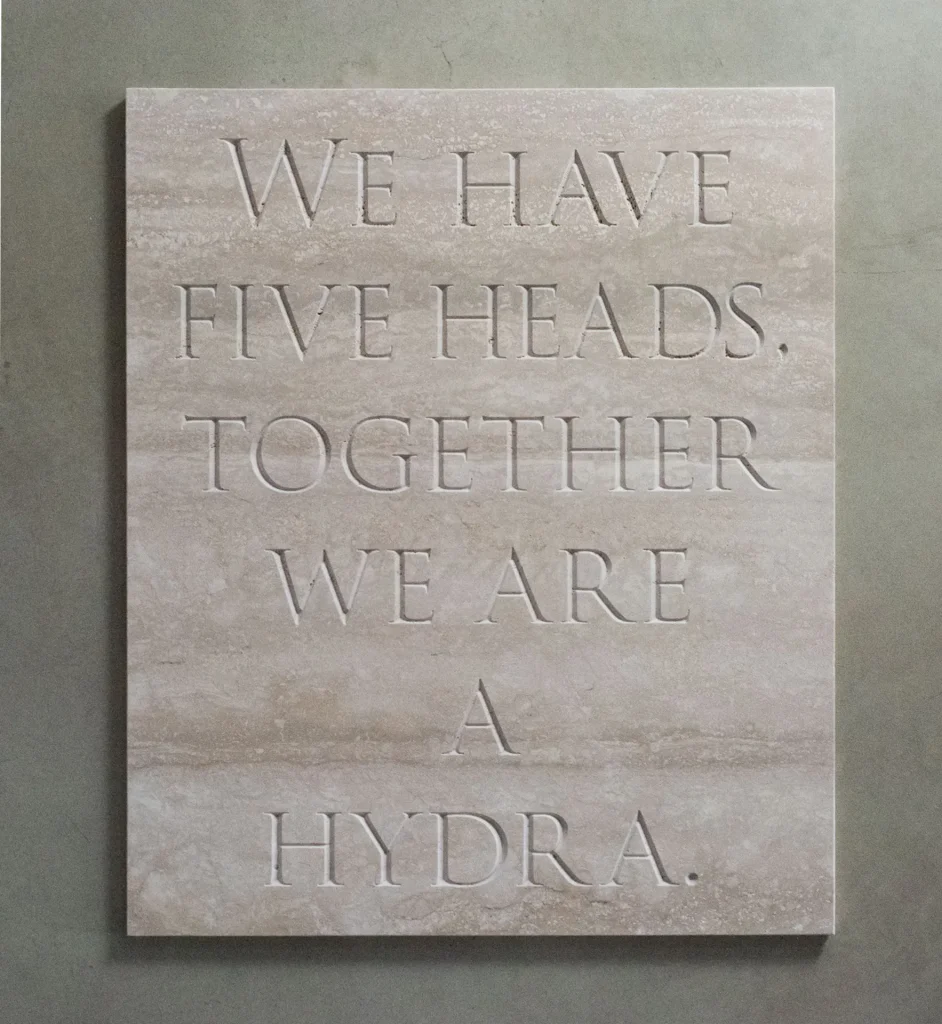 immagine per “We have five heads...”, 2020. Incisione su marmo di Travertino, cm 90 x 76 x 2. Courtesy l’artista e galleria Gilda Lavia